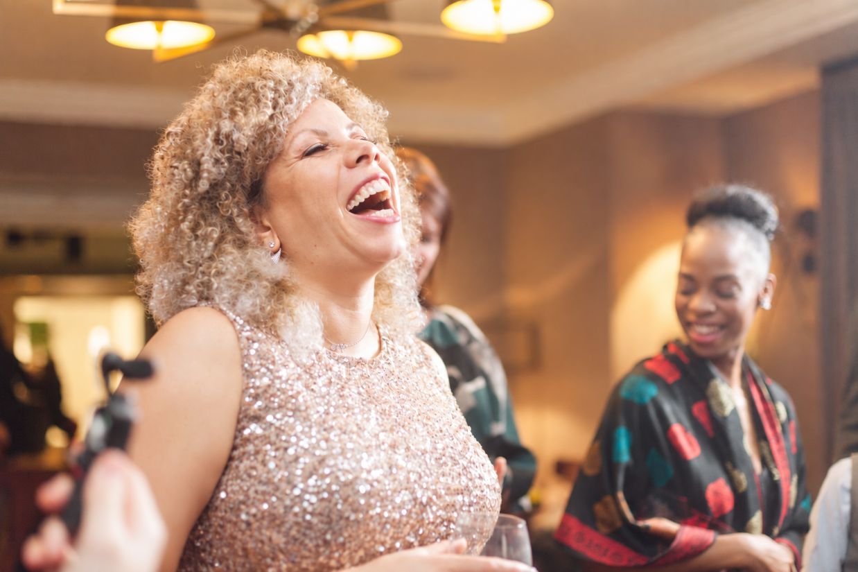 Guests at a Christmas party watching Close-Up Chris perform